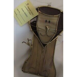 Stained glass leaves and lion handmade ornaments hang in window